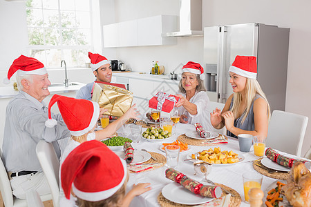 家庭互换圣诞节礼礼物男人住所桌子微笑女孩交换孩子公寓厨房大家庭图片
