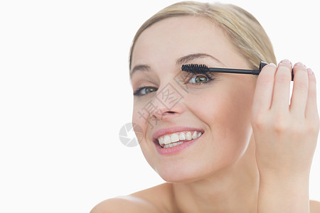 年轻女性用玛斯卡拉刺眼的近视肖像编造眼睛化妆品幸福睫毛膏皮肤金发女郎睫毛女士头发图片