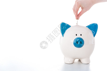 手把硬币放入蓝白小猪银行美术陶瓷经济推杆配售现金金融手绘蓝色储蓄图片