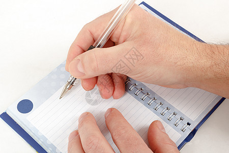 开始在笔记上写字的手特写铅笔工具男人白色办公室蓝色写作手指棕色空白图片