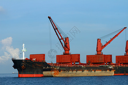 装载起重机的船舶货物海岸商品港口船运载体海洋血管金属贸易商业图片