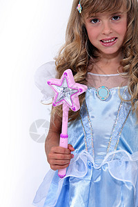 一个穿着服装的小女孩肖像童年乐趣打扮派对魔法棒丝绸生日微笑工作室星星图片