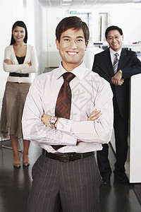 充满自信的年轻商务人士在办公室团队面前站立一队的肖像图片