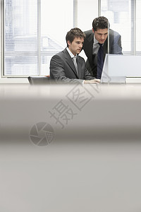 在办公室用笔记本电脑向男同事展示商业人项目图片