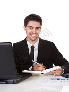 商务人士在日记里写笔记写作男人意图管理人员就业阅读人士公司桌子工人图片
