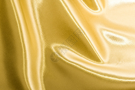 金丝奢华海浪材料黄色涟漪织物曲线金子布料纺织品背景图片