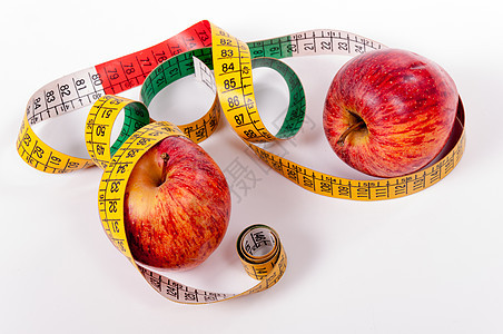 磁带测量和红苹果仪器饮食黄色水果运动厘米健身健康治疗重量图片