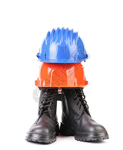 坚硬的帽子和工作靴子安全帽头盔蓝色衣服防护职业红色安全预防脚趾图片