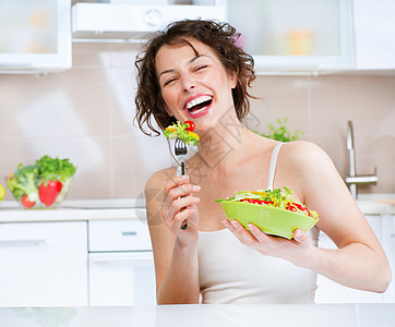 美丽的女孩吃蔬菜蔬菜沙拉 饮食概念 美食早餐午餐微笑乐趣减肥重量损失女性厨房身体图片