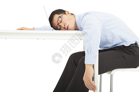 疲劳过度的商务人士睡在桌子上图片