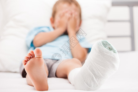 小男孩 腿脚跟骨折或br上贴着石膏绷带的幼小男孩保险男人脚跟医院事故疼痛男生治疗赤脚解剖学图片