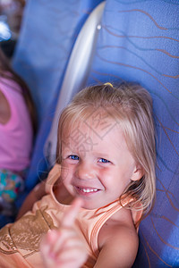 坐在飞机上笑笑笑的小女孩孩子们乘客工艺窗户家庭旅游兴趣航班孩子闲暇图片