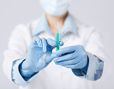 持有注射注射针管的女医生手术乐器麻醉流感女士情况面具剂量胰岛素药物图片