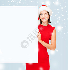 戴着空白白板的圣塔帮手帽的妇女销售裙子假期快乐帮手微笑折扣海报帽子广告图片