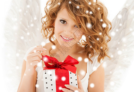 带着圣诞礼物的快乐少女天使女孩礼物天堂雪花卷曲微笑幸福盒子翅膀青少年福利图片