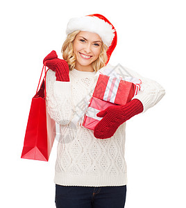戴圣塔女帮手帽和袋装购物袋的妇女庆典销售礼物女孩帽子快乐奢华假期购物零售图片