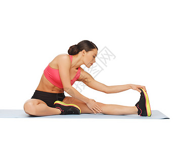 在地板上做运动的女运动员拉丁瑜伽地面肌肉锻炼腹肌有氧运动耐力健身房训练图片