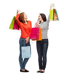 2个带着购物袋笑着的少女女孩零售财富奢华提倡者微笑假期快乐购物季节女孩们图片