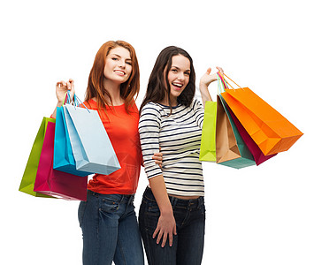 2个带着购物袋笑着的少女女孩假期零售顾客销售财富消费者青少年购物狂礼物购物图片