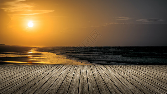 木制倾斜日落阳光海洋旅行海浪太阳假期反射橙子支撑天空图片