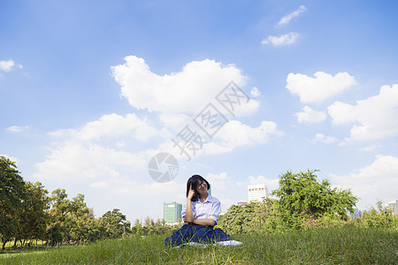 坐在草坪上的学生功课校园草地大学青年青少年教育天空学校女士学习图片