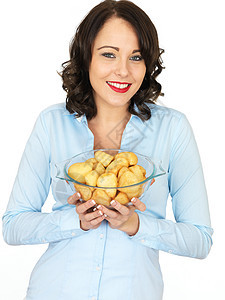 持有一碗烤土豆的年轻女子晚餐食物黑发服务厨师女孩白色吃饭时间女性图片