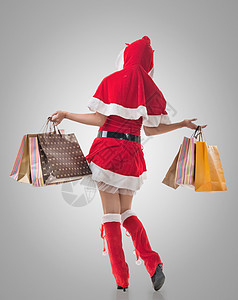 持有购物袋的圣诞女孩女性零售消费者购物中心魅力商业销售女士庆祝假期图片