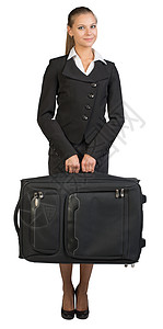 女商务人士拿着手提箱 看着照相机 微笑工作轮子女士游客照片职业航程手提包行李员工图片