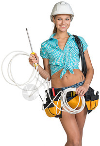 戴硬帽子和握着有线圈的工具带的妇女螺丝刀层面工作牛仔裤安全帽电缆卷尺绳索仪器胶带图片