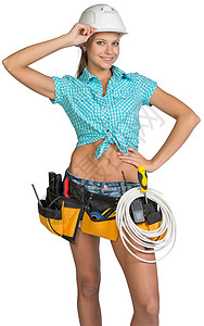 穿着硬帽子和工具腰带的妇女边框绝缘精神卷尺安全帽工作室工作牛仔裤电缆对讲机图片