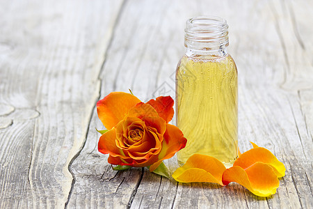 浴油和橙色玫瑰药品橙子温泉芳香液体治疗平衡奢华疗法花瓣图片