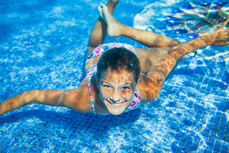 青少年游泳水下女孩女孩闲暇喜悦蓝色飞沫游泳衣活动身体乐趣运动背景