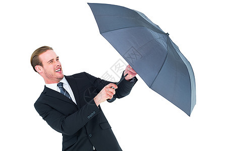 商务人士持有保护伞来保护自己职业庇护所套装领带黑色衬衫夹克商业商务男人图片