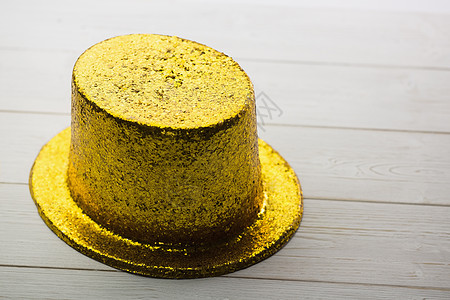 黄金党帽子闪光派对乐趣桌子金子背景图片