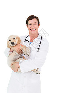 带着可爱的狗在她怀里微笑的兽医宠物工作医疗快乐动物金色女性女士专家家畜图片
