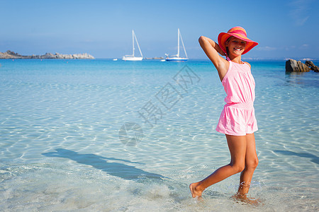 海滩上的女孩喜悦海洋家庭闲暇裙子帽子孩子女性海岸太阳图片