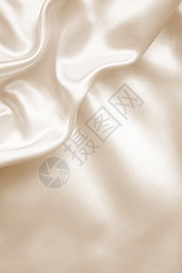 优雅的金丝绸作为婚礼背景 在塞皮亚纺织品材料折痕调子棕褐色版税窗帘布料新娘投标图片