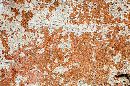 含白洗和橙色油漆残余物的混凝土表面粉饰石墙建造石灰材料石灰水裂缝风化建筑石膏图片