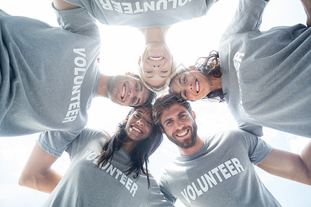 快乐的志愿者们聚集在一起女士志愿者朋友服务团结圆圈志愿团队帮助捐赠图片
