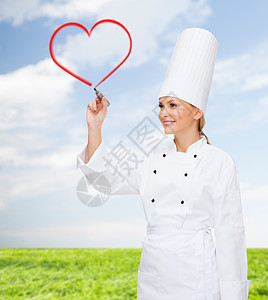 微笑的女厨师在空气中发红心服务管理人员女孩食谱餐厅蓝色绘画工作屏幕快乐图片
