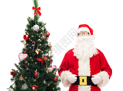 穿着圣诞树圣克劳斯装扮的人假期老年帽子季节胡须派对戏服男性惊喜眼镜图片