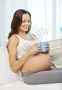 在家喝茶的快乐孕妇和在家里喝茶的杯子女性饮料腹部生活肚子母亲母性父母保健婴儿图片