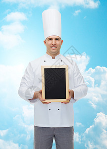 手持空白菜单板的快乐的男厨师厨师美食男人烹饪职业木板菜单餐厅工作食物蓝色图片