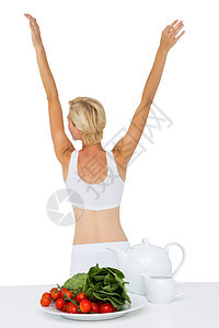 身材适合的女士在伸展身体文胸双臂盘子竞技调子护理运动服饮食女性菠菜图片