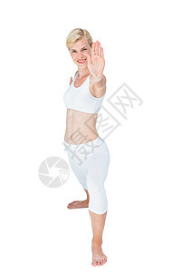 身材适合的女士在伸展身体女性护理金发女郎运动服运动微笑竞技瑜伽调子平衡图片
