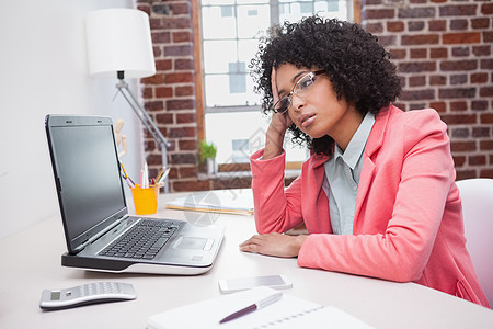 坐在办公桌旁的有压力的女临时工公司电脑工作机构商业专业女士办公室笔记本人士图片