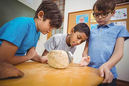 学生们用放大镜看着岩石地质学调查学校搜索小学生知识童年瞳孔混血班级图片