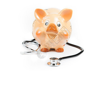 在小猪银行面前的听诊器 省钱的概念图片