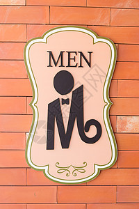 厕所砖墙上的现代标志 文字“男人”图片