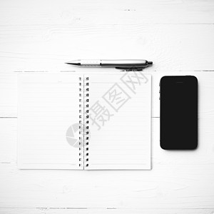 带有笔记本和笔黑白颜色样式的手机记事本笔记技术工作文档电话屏幕办公室商业木头图片